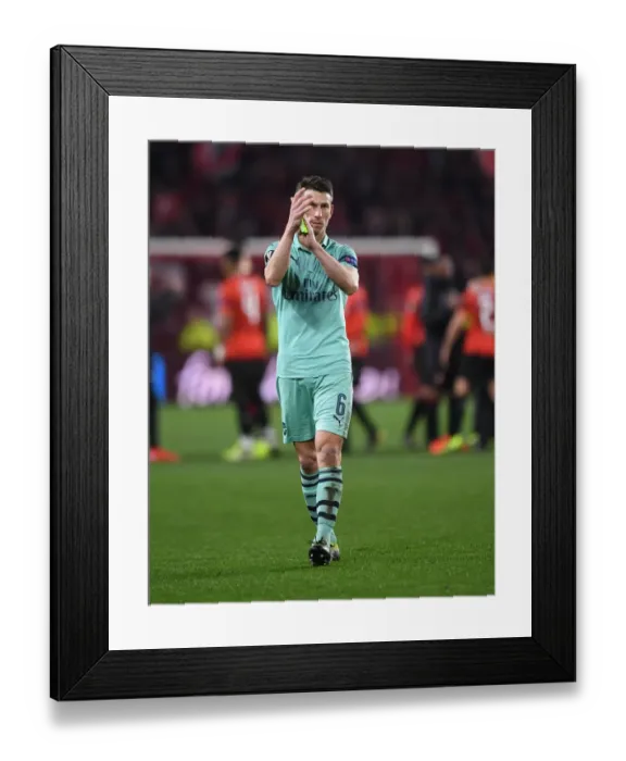 Framed Print : Arsenal's Laurent Koscielny Celebrates with Fans after First Leg of Europa League Match against Stade Rennais Framed Print : Arsenal's Laurent Koscielny Celebrates with Fans after First Leg of Europa League Match against Stade Rennais