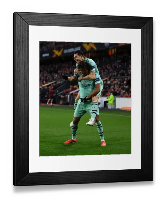Framed Print : Alex Iwobi and Granit Xhaka Celebrate Goal: Arsenal's Winning Moment against Stade Rennais in Europa League