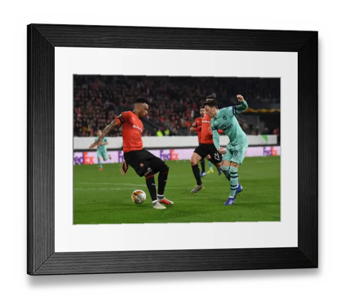 Framed Print : Mesut Ozil Faces Pressure: Arsenal vs. Stade Rennais, UEFA Europa League Round of 16 First Leg Framed Print : Mesut Ozil Faces Pressure: Arsenal vs. Stade Rennais, UEFA Europa League Round of 16 First Leg