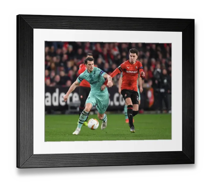 Framed Print : Granit Xhaka vs. Adrien Hunou: Intense Clash in Arsenal's Europa League Battle with Stade Rennais
