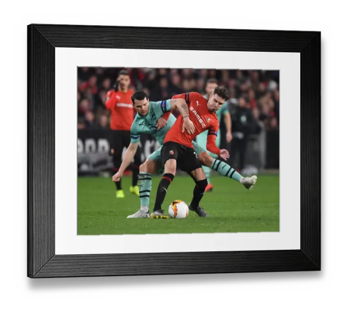 Framed Print : Granit Xhaka vs. Adrien Hunou: Clash in the UEFA Europa League as Arsenal Face Stade Rennais
