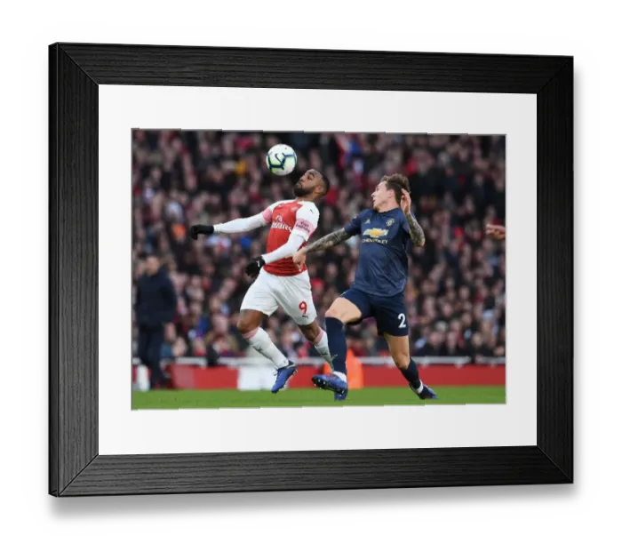 Framed Print : Lacazette vs. Lindelof: A Premier League Battle at Emirates Stadium