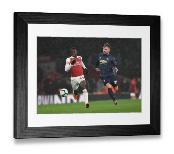 Framed Print : Arsenal's Eddie Nketiah Clashes with Manchester United's Luke Shaw in Premier League Showdown Framed Print : Arsenal's Eddie Nketiah Clashes with Manchester United's Luke Shaw in Premier League Showdown