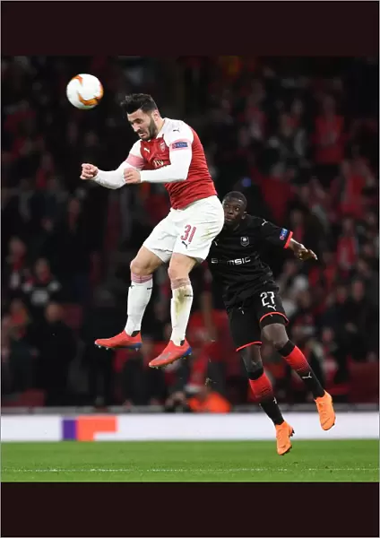 Arsenal vs. Stade Rennais: Sead Kolasinac Leaps Over Hamari Traore in Europa League Clash