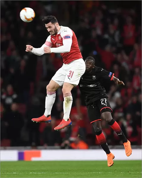 Arsenal vs. Stade Rennais: Sead Kolasinac Leaps Over Hamari Traore in Europa League Clash