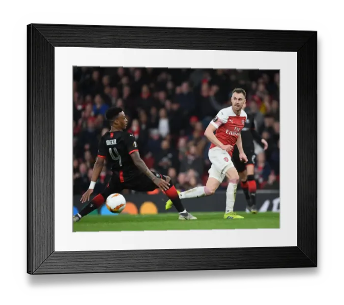 Framed Print : Arsenal vs Stade Rennais: Aaron Ramsey Clashes with Mexer in Europa League Showdown Framed Print : Arsenal vs Stade Rennais: Aaron Ramsey Clashes with Mexer in Europa League Showdown
