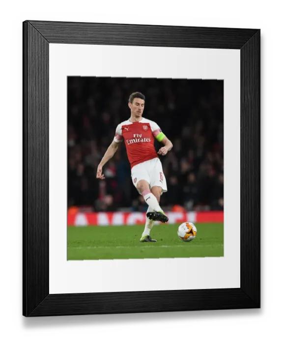 Framed Print : Laurent Koscielny Focuses Ahead of Arsenal's Europa League Showdown Against Stade Rennais