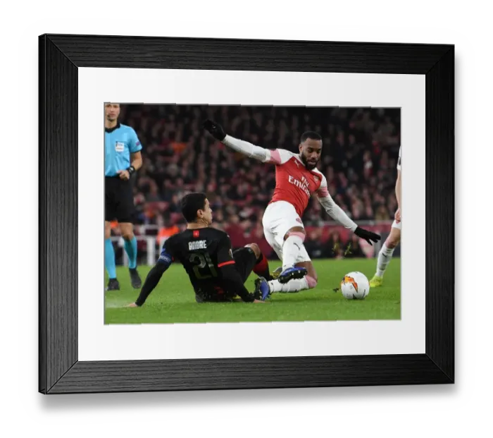 Framed Print : Arsenal's Lacazette Clashes with Rennais Andre in Europa League Showdown Framed Print : Arsenal's Lacazette Clashes with Rennais Andre in Europa League Showdown