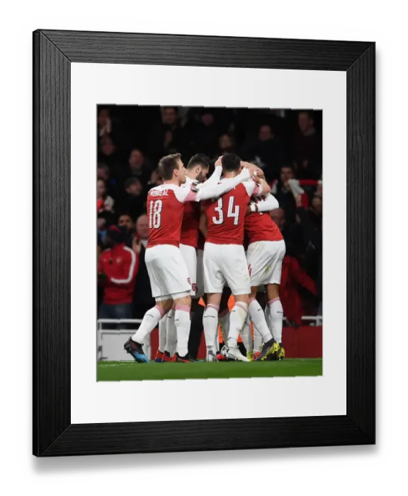 Framed Print : Arsenal Celebrate Double Strike Against Stade Rennais in Europa League
