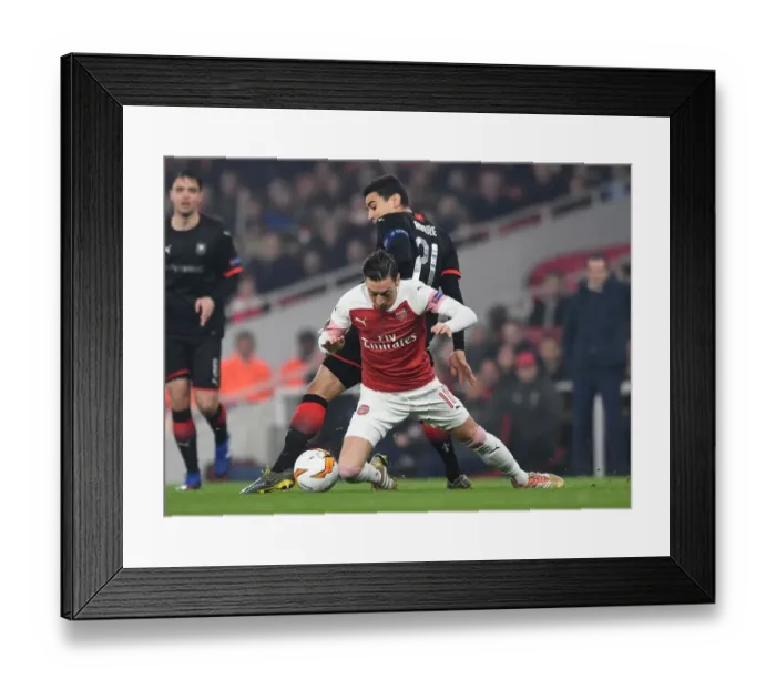 Framed Print : Mesut Ozil vs. Benjamin Andre: Clash in the Europa League Round of 16 between Arsenal and Stade Rennais Framed Print : Mesut Ozil vs. Benjamin Andre: Clash in the Europa League Round of 16 between Arsenal and Stade Rennais