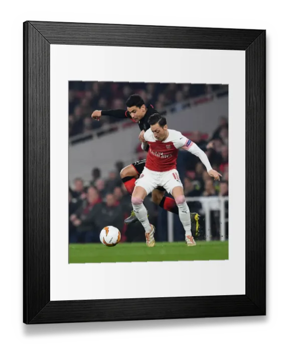 Framed Print : Mesut Ozil vs Benjamin Andre: A Battle in the Arsenal v Stade Rennais UEFA Europa League Clash