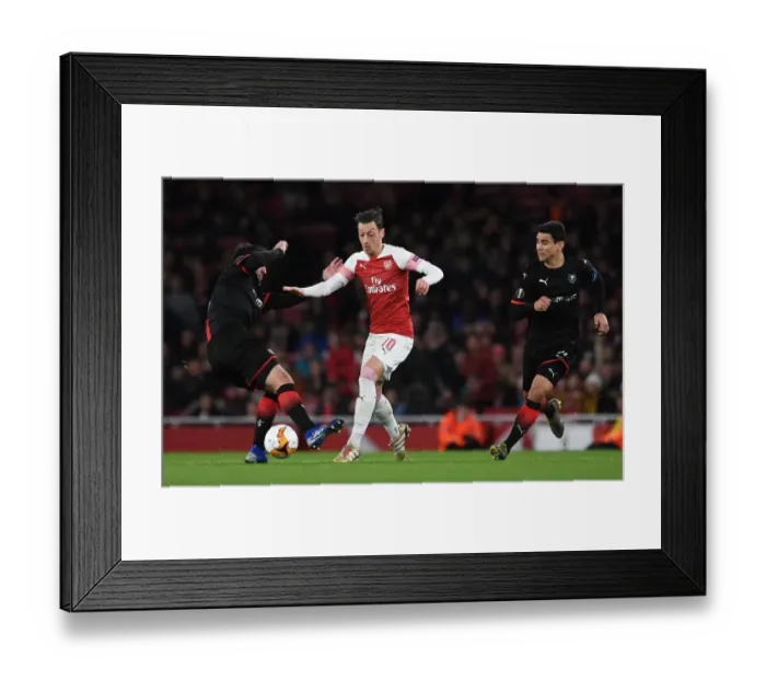 Framed Print : Mesut Ozil Clashes with Clement Grenier and Benjamin Andre in Arsenal's Europa League Showdown against Stade Rennais