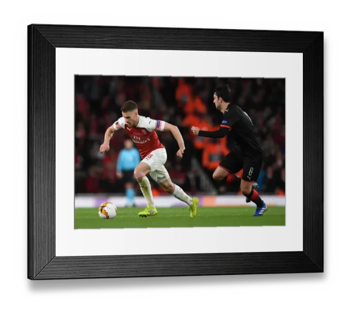 Framed Print : Arsenal's Aaron Ramsey Fends Off Clement Grenier in Europa League Clash Framed Print : Arsenal's Aaron Ramsey Fends Off Clement Grenier in Europa League Clash