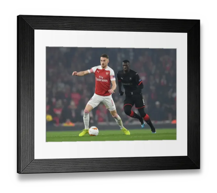 Framed Print : Clash at Emirates: Ramsey vs. Niang in Europa League Showdown Framed Print : Clash at Emirates: Ramsey vs. Niang in Europa League Showdown