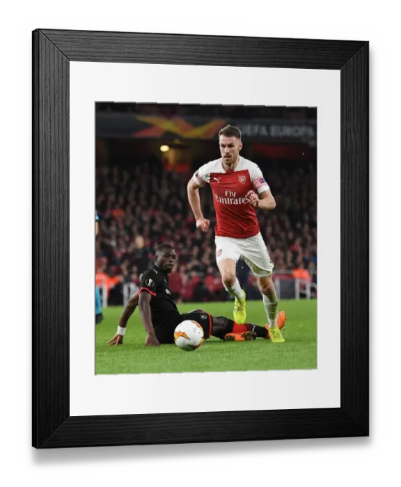 Framed Print : Aaron Ramsey Outmaneuvers Hamari Traore in Arsenal's Europa League Clash