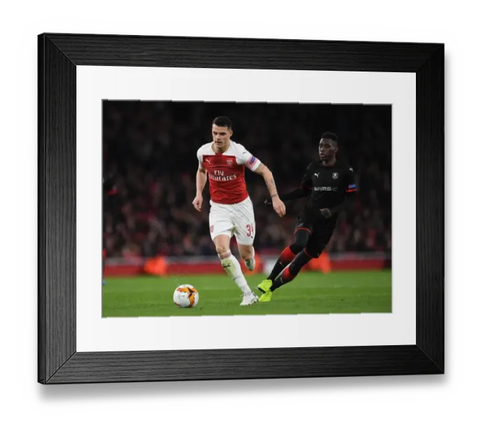 Framed Print : Xhaka vs Sarr: A Europa League Battle – Arsenal's Granit Xhaka and Stade Rennais Ismaila Sarr Clash in Dramatic Showdown Framed Print : Xhaka vs Sarr: A Europa League Battle – Arsenal's Granit Xhaka and Stade Rennais Ismaila Sarr Clash in Dramatic Showdown