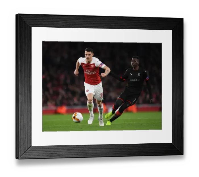 Framed Print : Xhaka vs Sarr: A Europa League Battle at Emirates Stadium