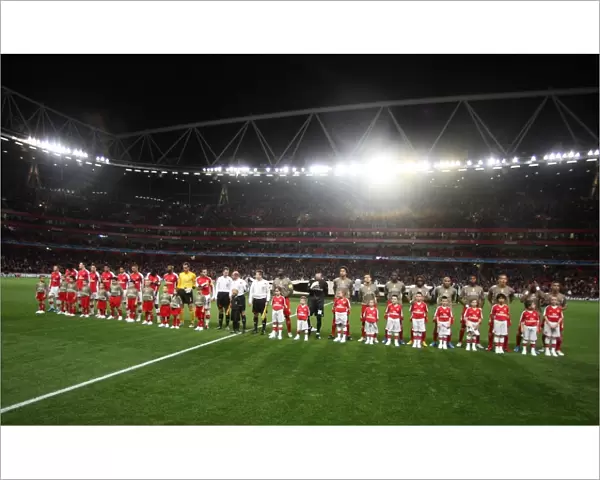 The Arsenal and Liege teams line up with their mascots