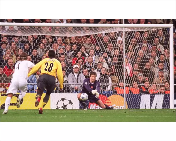 Jens Lehmann (Arsenal) punches clear under pressure from Sergio Ramos (Real)