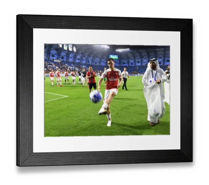 Framed Print : Mesut Ozil Connects with Arsenal Fans: Post-Match Ball Sharing in Dubai, 2019 Framed Print : Mesut Ozil Connects with Arsenal Fans: Post-Match Ball Sharing in Dubai, 2019