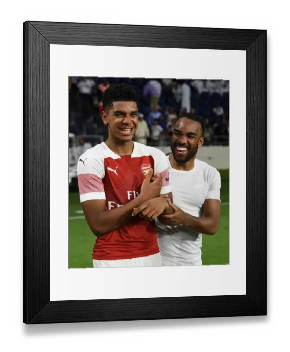 Framed Print : Arsenal's John-Jules and Lacazette Celebrate after Al-Nasr Friendly Win