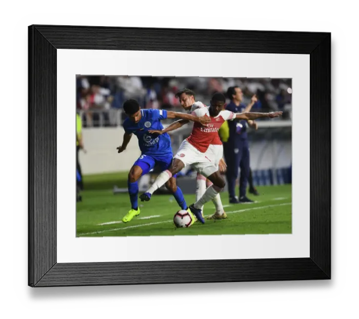 Framed Print : Clash of the Midfielders: Maitland-Niles vs. Saleh (Al-Nasr vs. Arsenal, 2018-19)