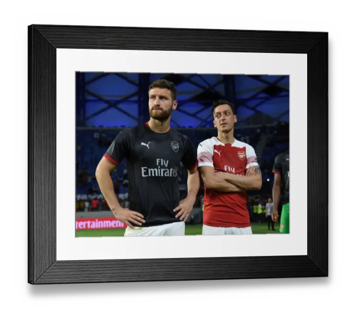 Framed Print : Arsenal's Ozil and Mustafi Share a Moment after Al-Nasr Friendly Match
