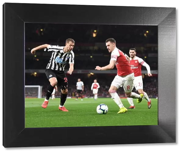 Arsenal's Ramsey Battles Lejeune in Intense Arsenal v Newcastle Premier League Clash
