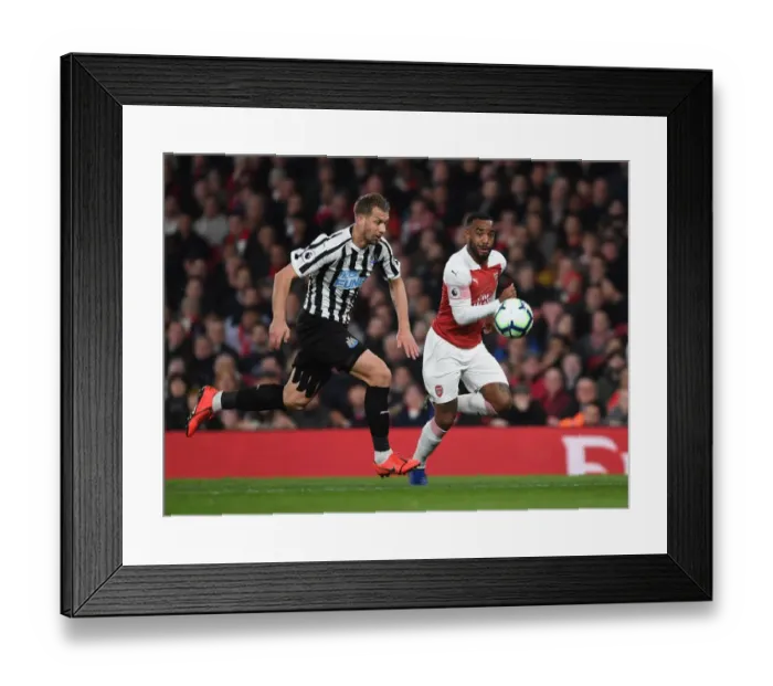 Framed Print : Arsenal's Lacazette vs. Newcastle's Lejeune: A Premier League Showdown Framed Print : Arsenal's Lacazette vs. Newcastle's Lejeune: A Premier League Showdown