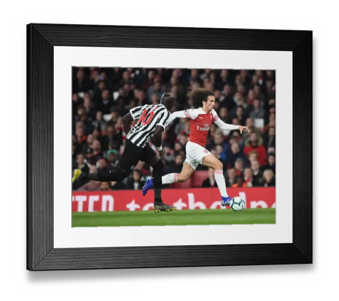 Framed Print : Arsenal's Matteo Guendouzi Outmaneuvers Newcastle's Mo Diame in Premier League Clash Framed Print : Arsenal's Matteo Guendouzi Outmaneuvers Newcastle's Mo Diame in Premier League Clash