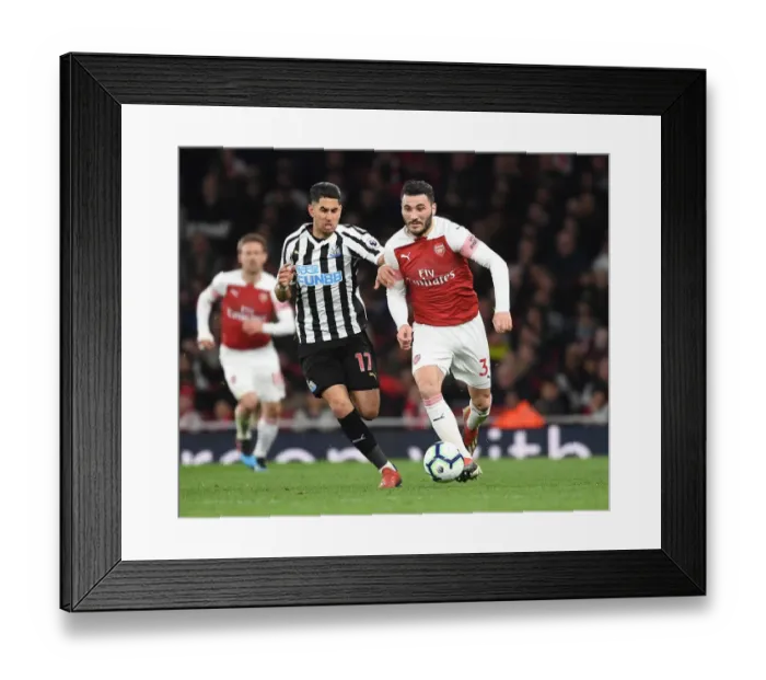 Framed Print : Arsenal's Sead Kolasinac Surges Past Newcastle's Ayoze Perez in Premier League Clash Framed Print : Arsenal's Sead Kolasinac Surges Past Newcastle's Ayoze Perez in Premier League Clash