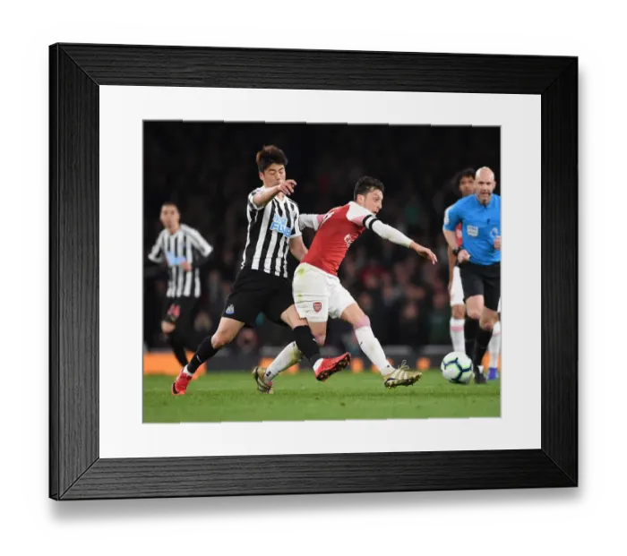Framed Print : Arsenal vs Newcastle United: Mesut Ozil Faces Off Against Ki Sung-Yueng in Premier League Clash Framed Print : Arsenal vs Newcastle United: Mesut Ozil Faces Off Against Ki Sung-Yueng in Premier League Clash