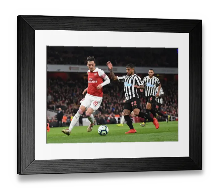 Framed Print : Mesut Ozil vs DeAndre Yedlin: Intense Battle at Arsenal's Emirates Stadium
