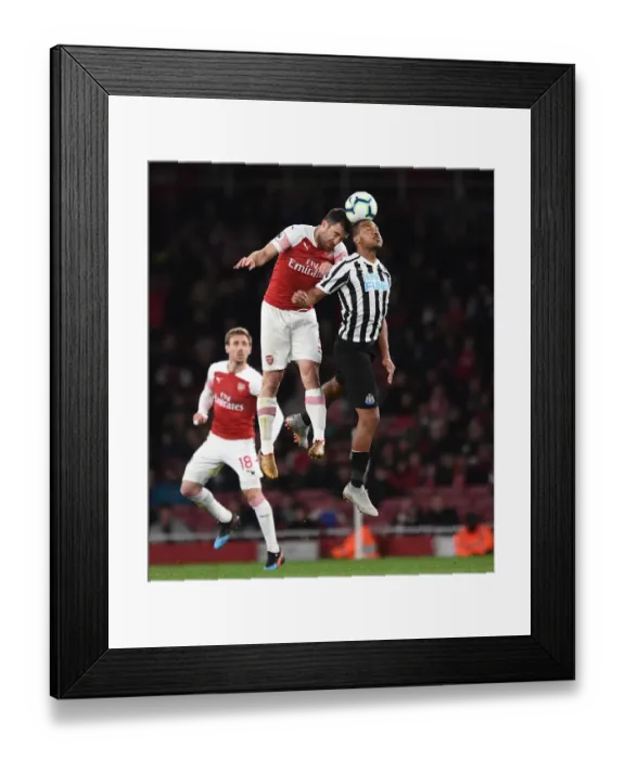 Framed Print : Arsenal vs Newcastle: Intense Battle between Rondon and Sokratis Framed Print : Arsenal vs Newcastle: Intense Battle between Rondon and Sokratis