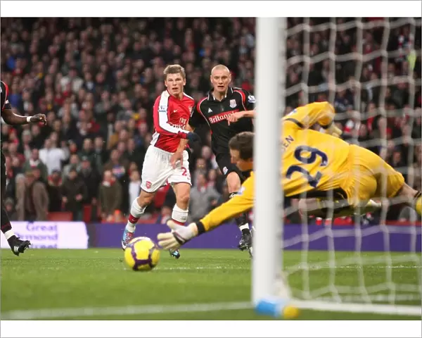 Andrey Arshavin shoots past Stoke City goalkeeper Thomas Sorensen to score the 1st Arsenal goal