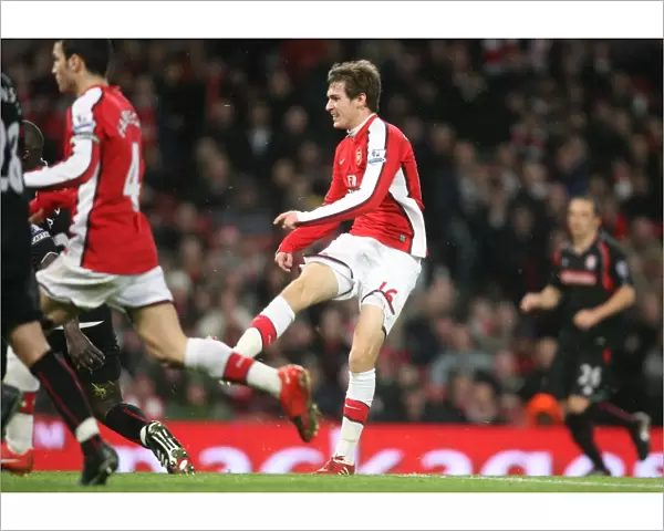 Aaron Ramsey shoots past Stoke goalkeeper Thomas Sorensen to score the 2nd Arsenal goal