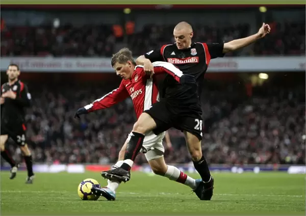 Andrey Arshavin holds off Andy Wilkinson (Stoke) on his way to scoring Arsenals 1st goal