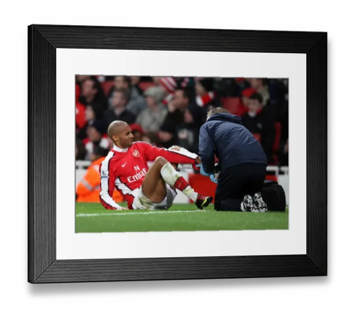 Framed Print : Armand Traore (Arsenal) is treated for an injury. Arsenal 2: 0 Stoke City Framed Print : Armand Traore (Arsenal) is treated for an injury. Arsenal 2: 0 Stoke City