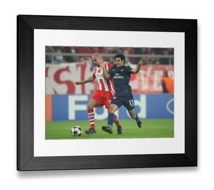 Framed Print : Carlos Vela (Arsenal) Raul Bravo (Olympiacos). Olympiacos 1: 0 Arsenal, UEFA Champions League