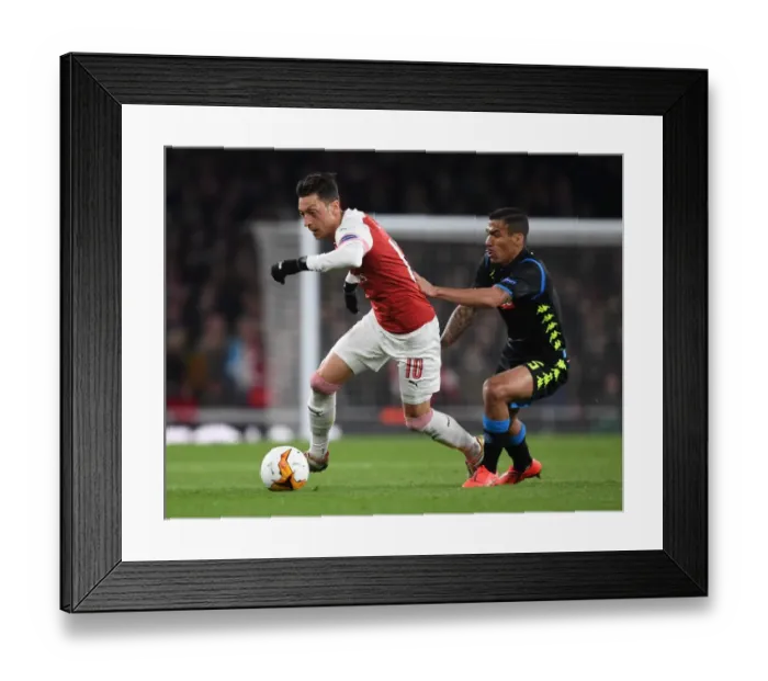 Framed Print : Arsenal's Mesut Ozil Outmaneuvers Napoli's Allan in Europa League Quarterfinal Clash Framed Print : Arsenal's Mesut Ozil Outmaneuvers Napoli's Allan in Europa League Quarterfinal Clash