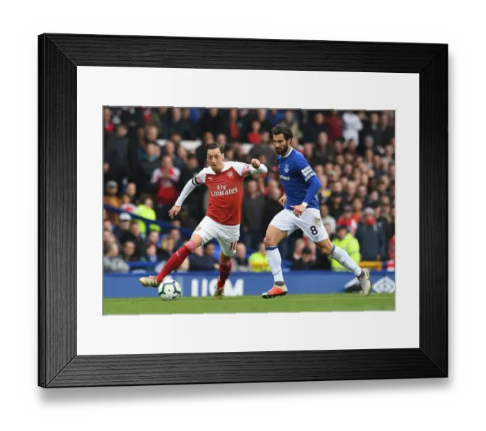 Framed Print : Mesut Ozil vs. Andre Gomes: Intense Battle at Goodison Park during Arsenal's Premier League Clash with Everton
