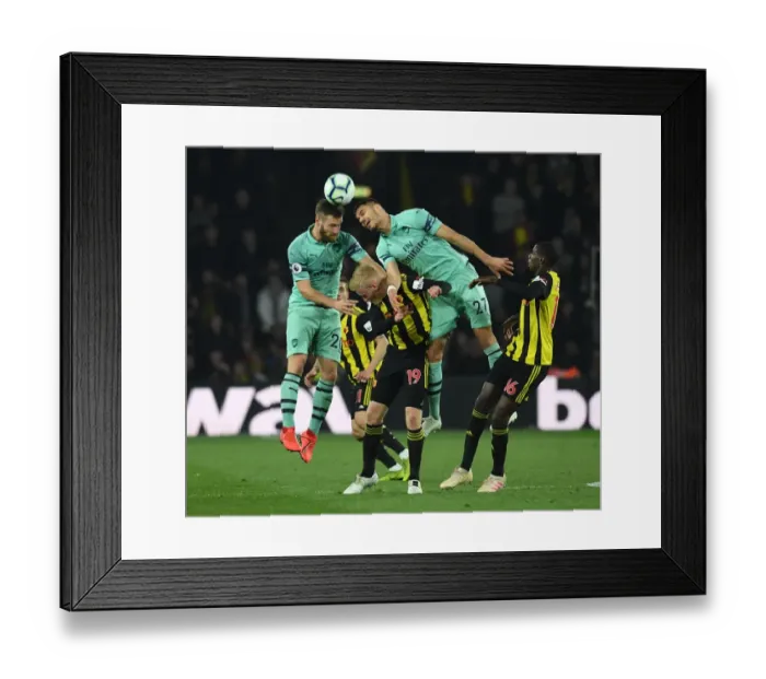 Framed Print : Clash at Vicarage Road: Mustafi and Mavropanos Go Head-to-Head Against Watford's Hughes