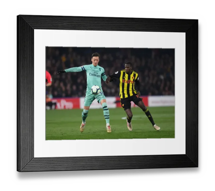 Framed Print : Intense Rivalry: Ozil vs Doucoure Showdown - Watford vs Arsenal Premier League (2018-19)