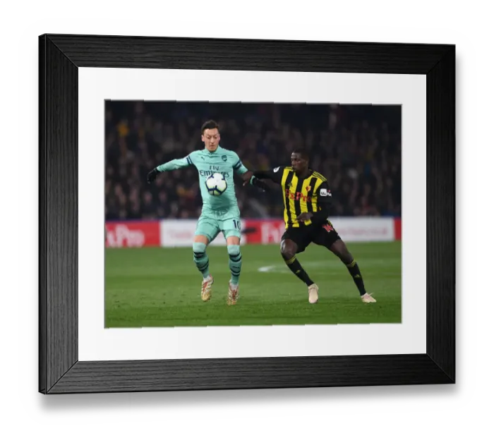 Framed Print : Intense Rivalry: Ozil vs Doucoure Clash - Watford vs Arsenal Premier League