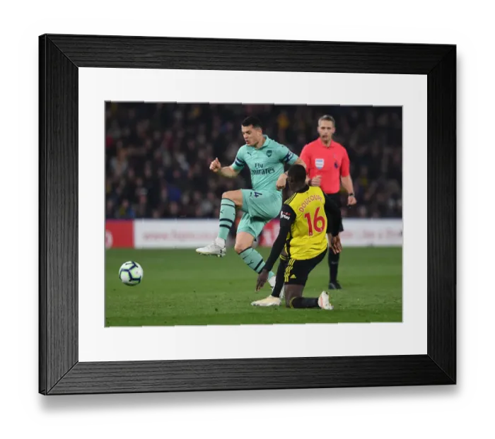 Framed Print : Clash at Vicarage Road: Xhaka vs. Doucoure in the Premier League Battle between Watford and Arsenal Framed Print : Clash at Vicarage Road: Xhaka vs. Doucoure in the Premier League Battle between Watford and Arsenal