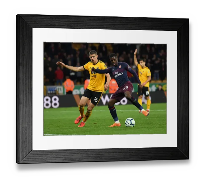 Framed Print : Arsenal's Nketiah Faces Off Against Wolverhampton's Coady in Premier League Clash