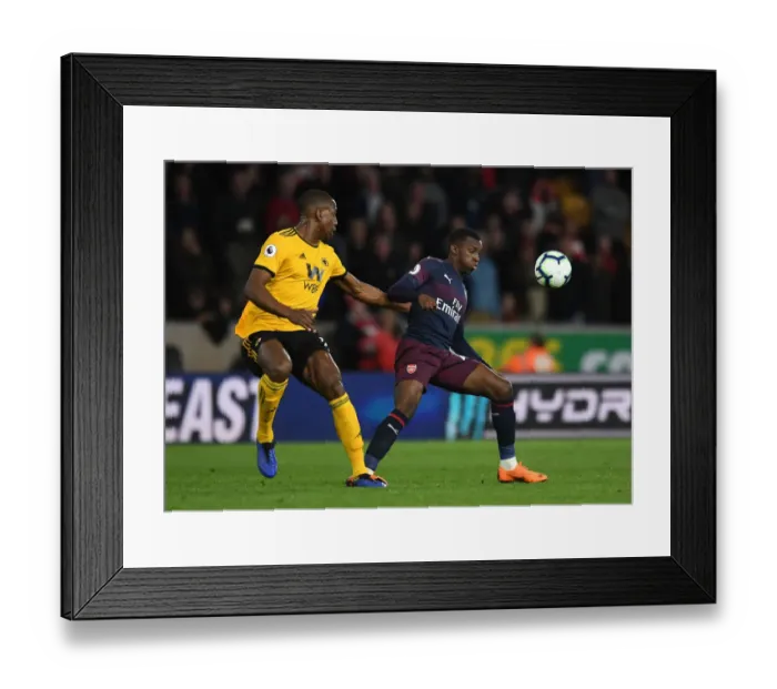 Framed Print : Arsenal's Eddie Nketiah Faces Off Against Wolves Willy Boly in Intense Premier League Clash Framed Print : Arsenal's Eddie Nketiah Faces Off Against Wolves Willy Boly in Intense Premier League Clash