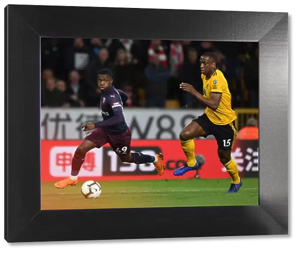 Arsenal's Eddie Nketiah Clashes with Wolves Willy Boly in Intense Premier League Showdown (2018-19)