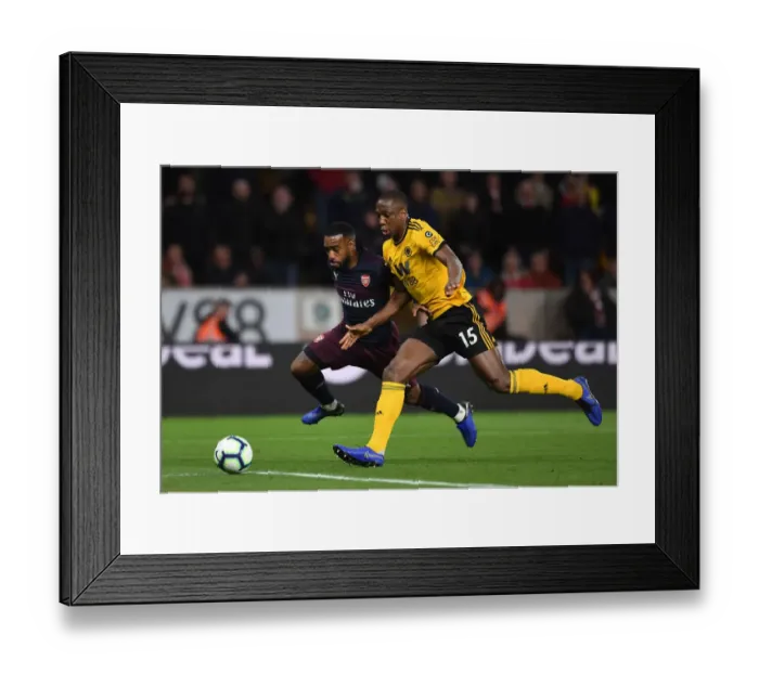 Framed Print : Arsenal's Lacazette Faces Off Against Wolves Boly in Premier League Clash (2018-19)