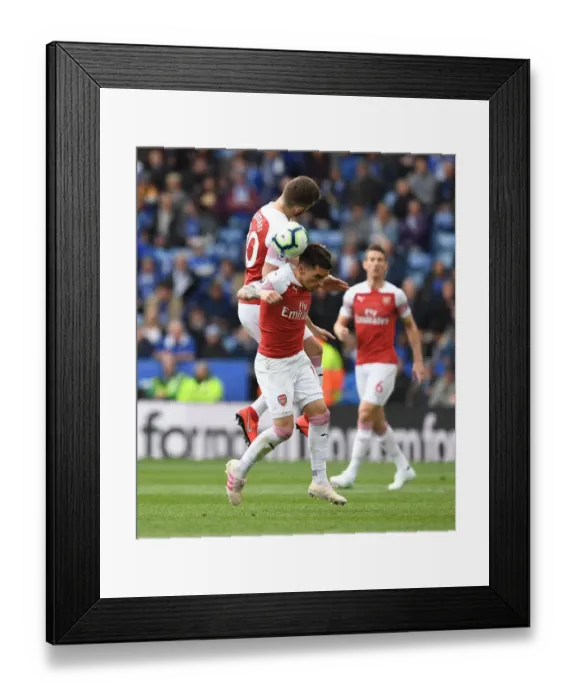 Framed Print : Clash at The King Power: Mustafi and Torreira Battle for the Ball in Leicester City vs Arsenal FC